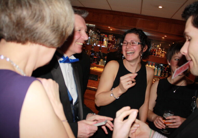 close up magician amazing guests after dinner at an event