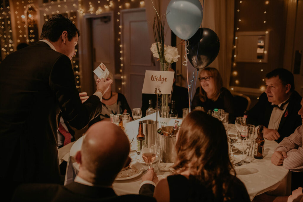 close up magician performing table magic at a corporate event