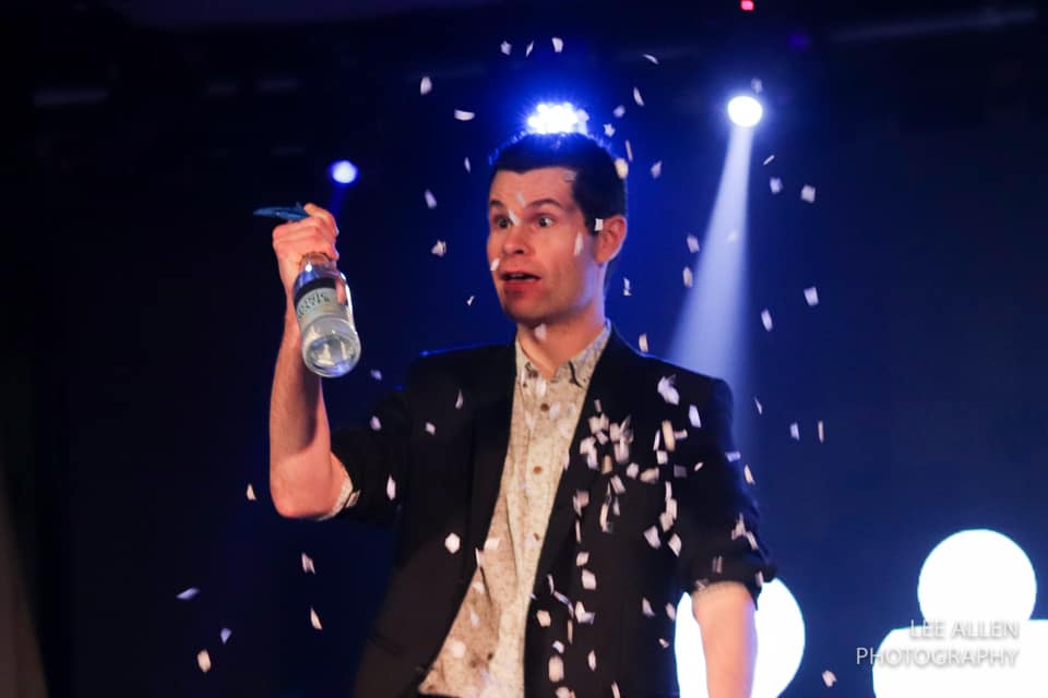 a magician performing a trick during an after dinner cabaret magic show